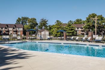 A swimming pool with chairs and umbrellas